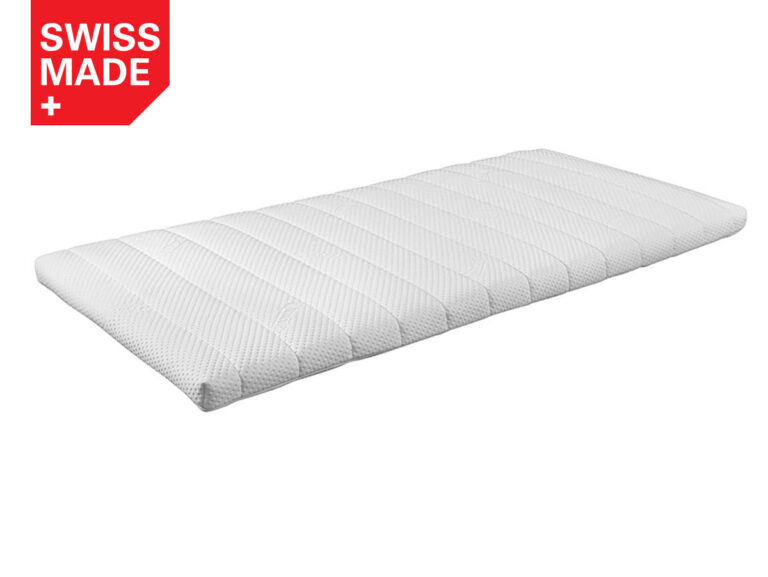 Eine weiße, rechteckige Matratzenauflage mit einer strukturierten Oberfläche ist auf weißem Hintergrund abgebildet. In der oberen linken Ecke befindet sich ein rotes Etikett mit der Aufschrift SWISS MADE und einem weißen Kreuzsymbol.